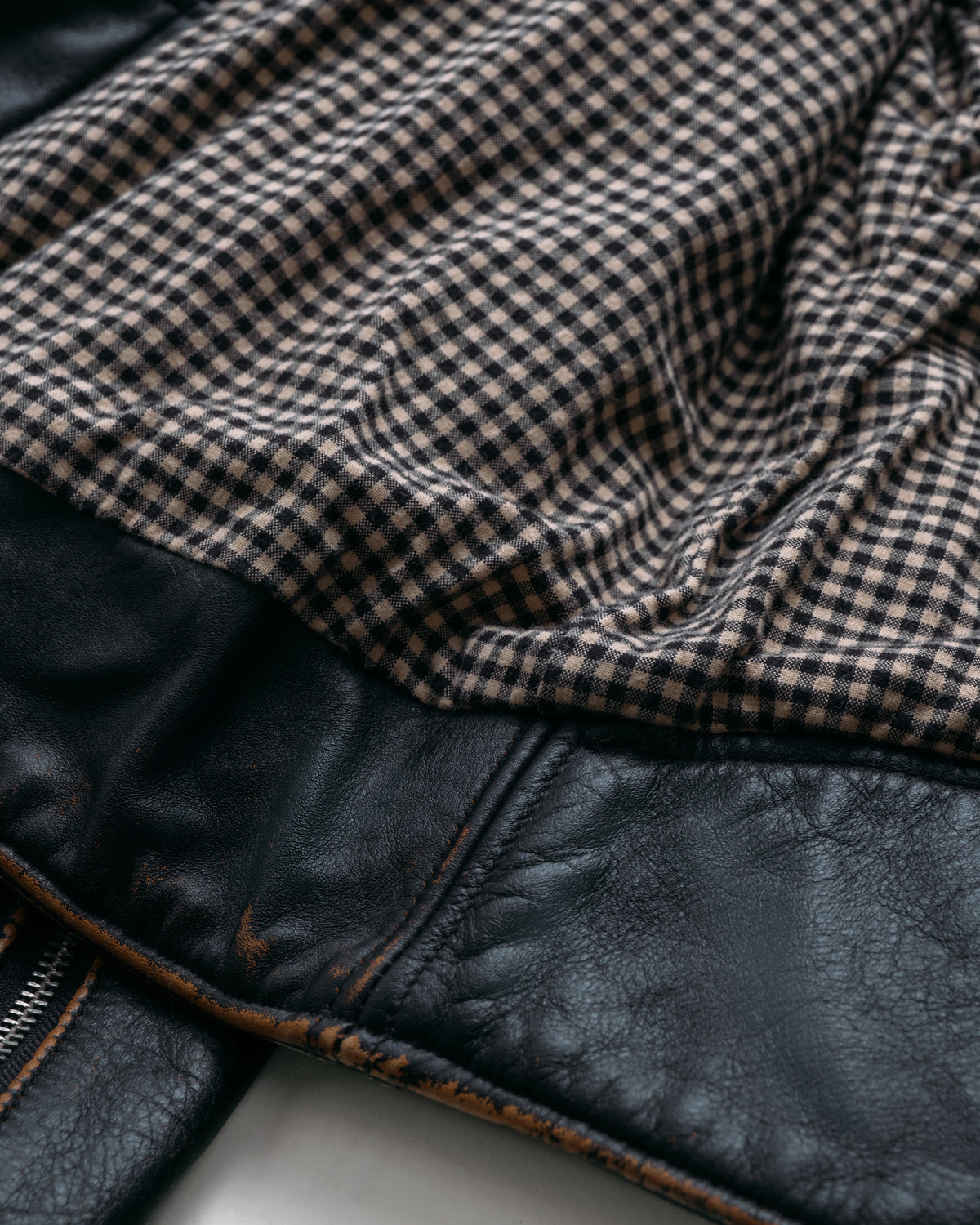 Close-up of a checkered fabric over leather material