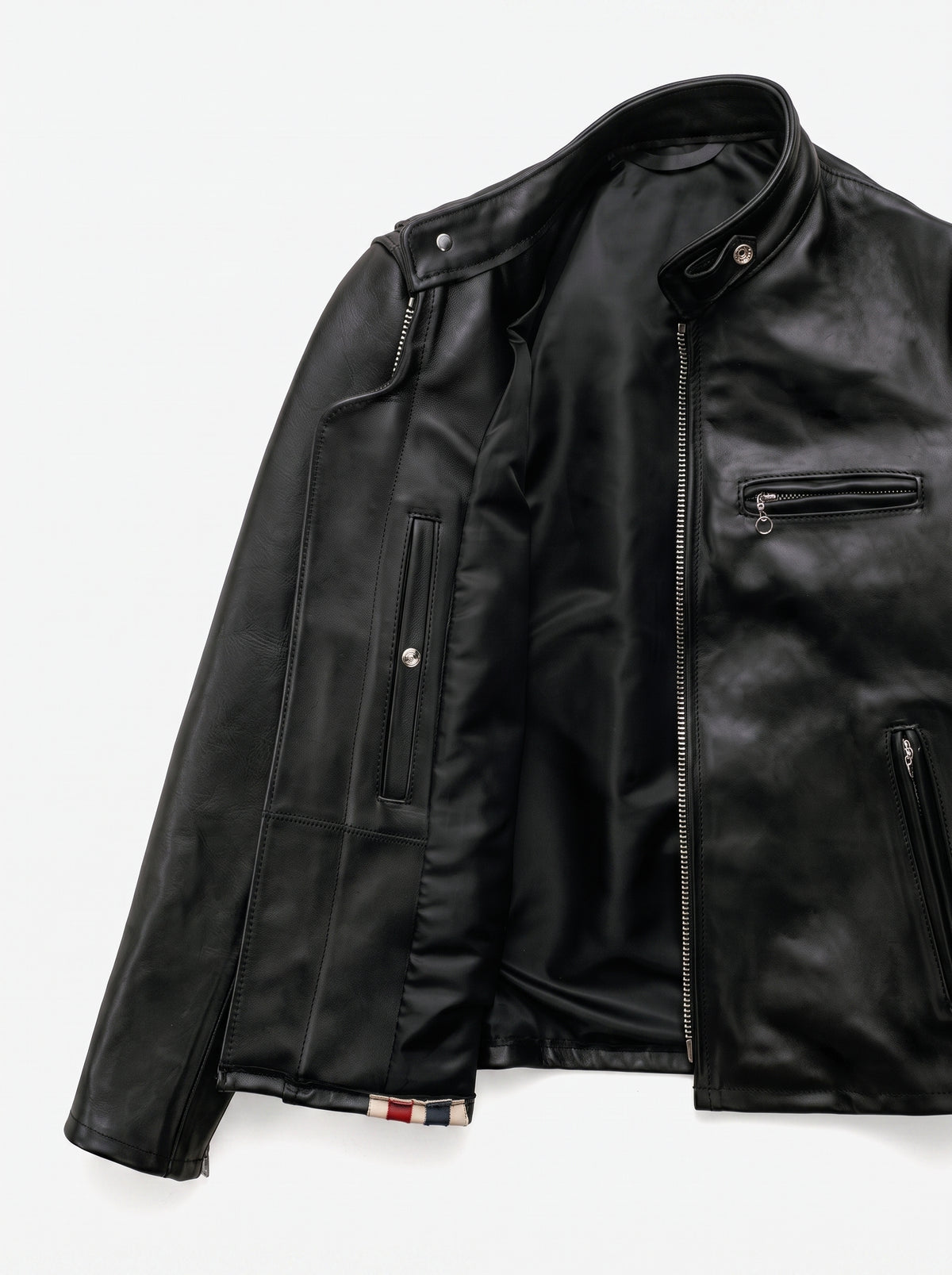 Black textured jacket with patterned lining on a light gray background