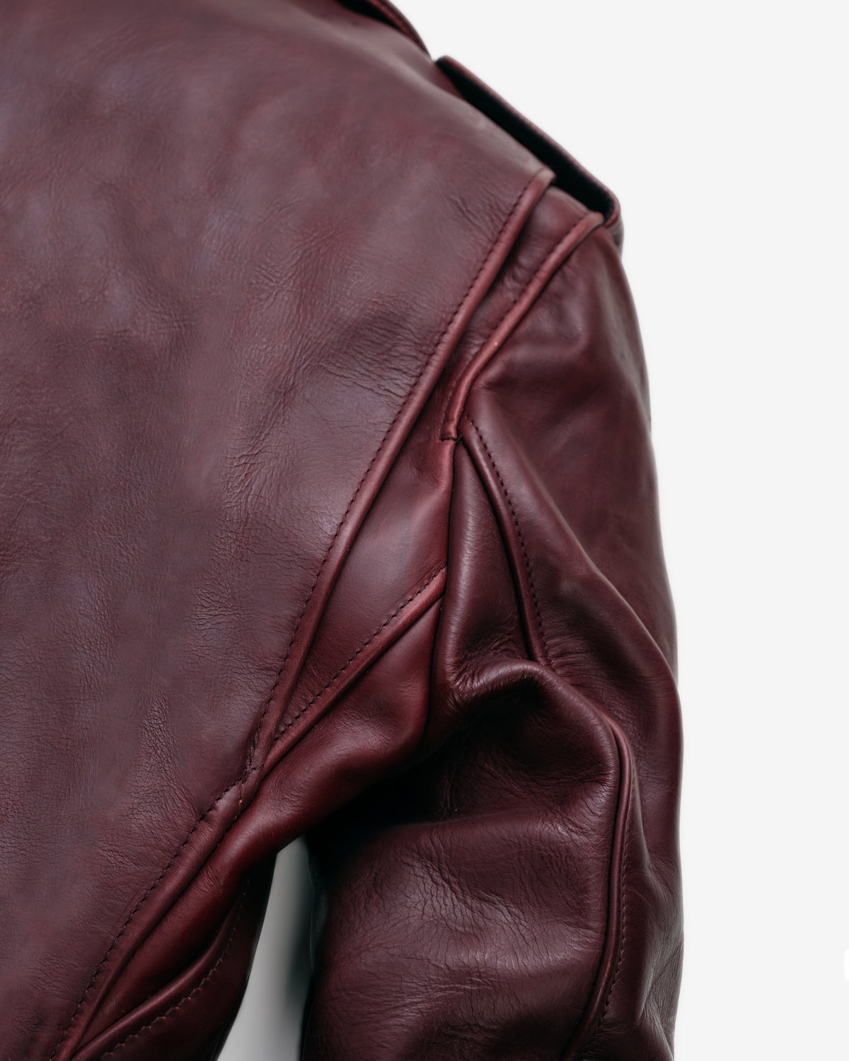 Close-up of a brown leather jacket on a white background