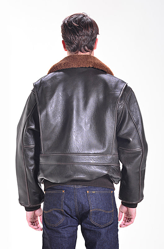 Person wearing a black leather jacket with a brown collar on a white background